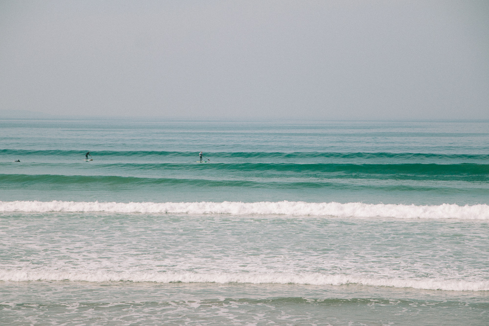 Surfers at Newgale Beach in Pembrokeshire