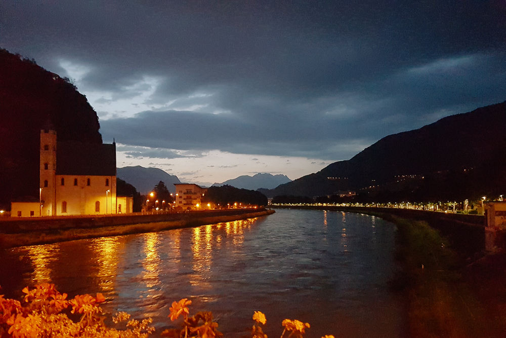 View over the river that runs through Trento at Night